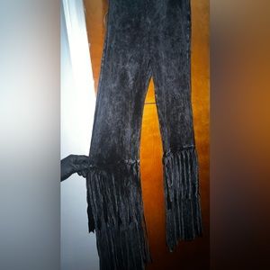 Pull on, bell bottom pants with fringe on bottom. Size large. Acid wash color